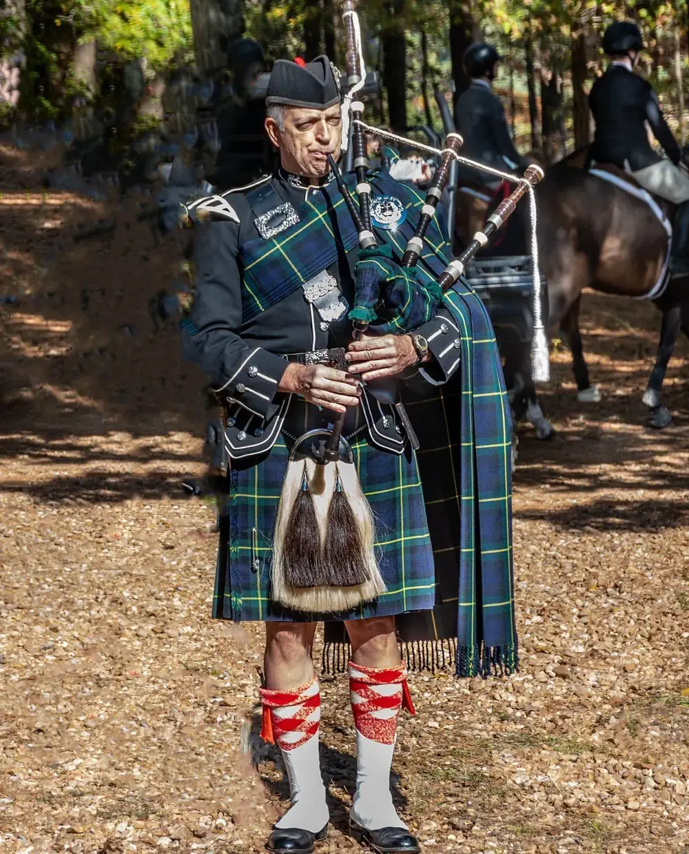 Tim Gordon in full dress, piping at the meet